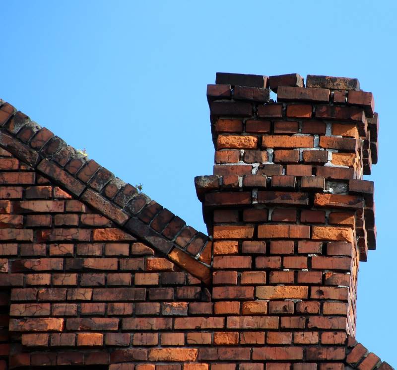 Damaged chimney on an Waterford home showing cracks and missing mortar